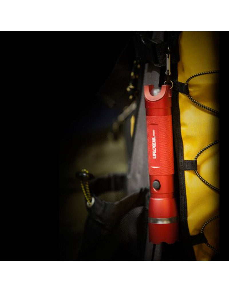 Life Gear Aluminum Search Light & Whistle attached to the side of a yellow backpack with the carabiner