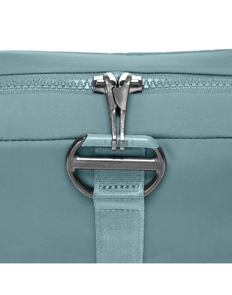 Close up of locking zipper pulls on fresh mint Pacsafe® CX Anti-theft Square Crossbody