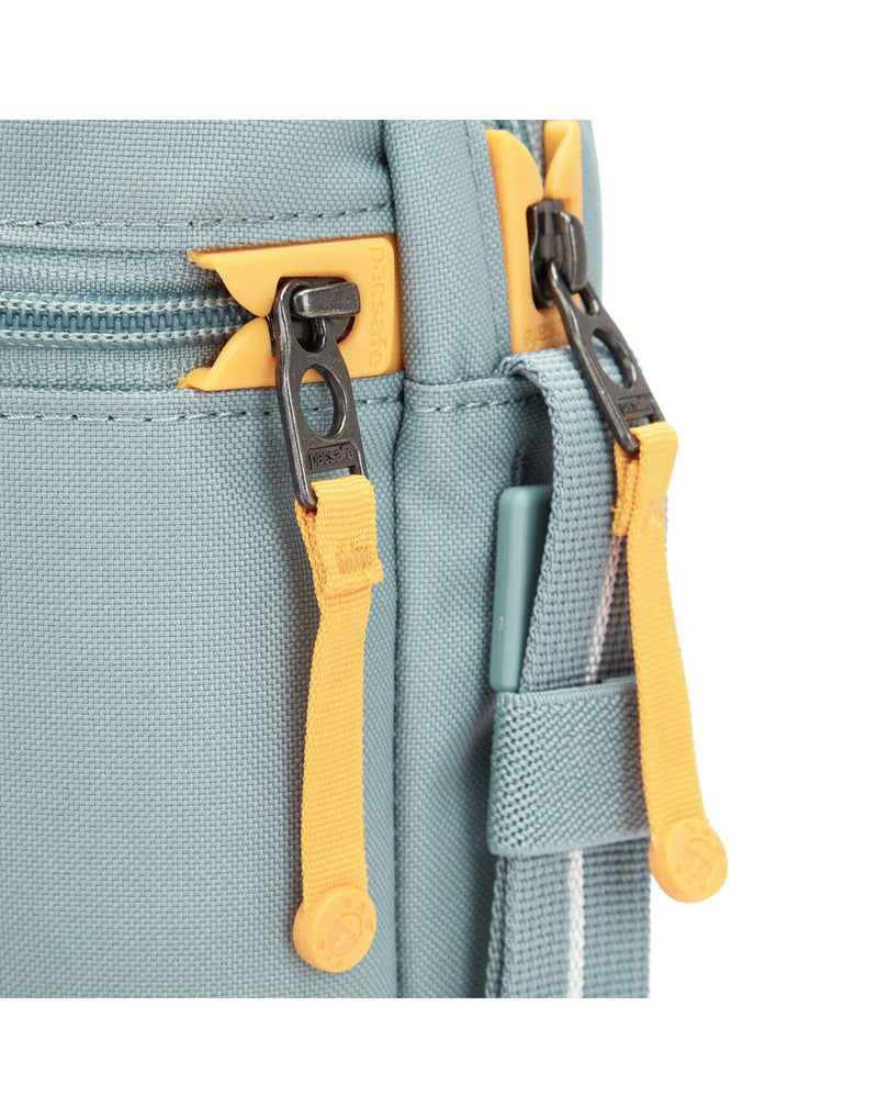 Pacsafe® GO Anti-Theft Festival Crossbody in fresh mint colour close-up of two zippers with dock locks.