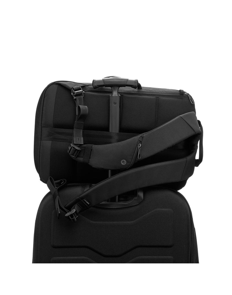 Pacsafe Metrosafe X Anti-Theft 16-Inch Commuter Backpack, black, on its side with a luggage handle through the back slot