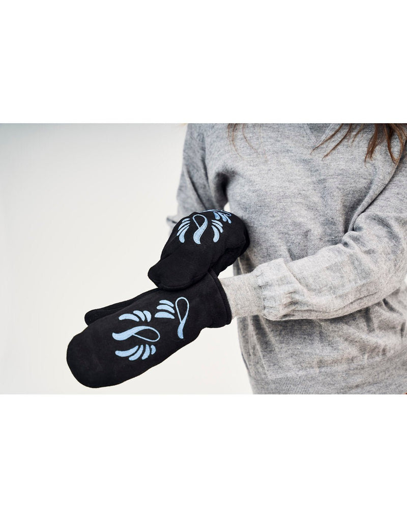Lifestyle image of woman wearing grey sweater and Raber Snowbird Mittens