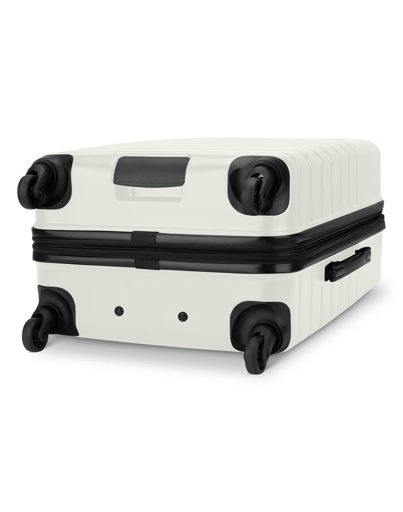 Roots Panorama 24" Hardside Expandable Spinner in tofu, white colour, bottom angled view of black spinner wheels