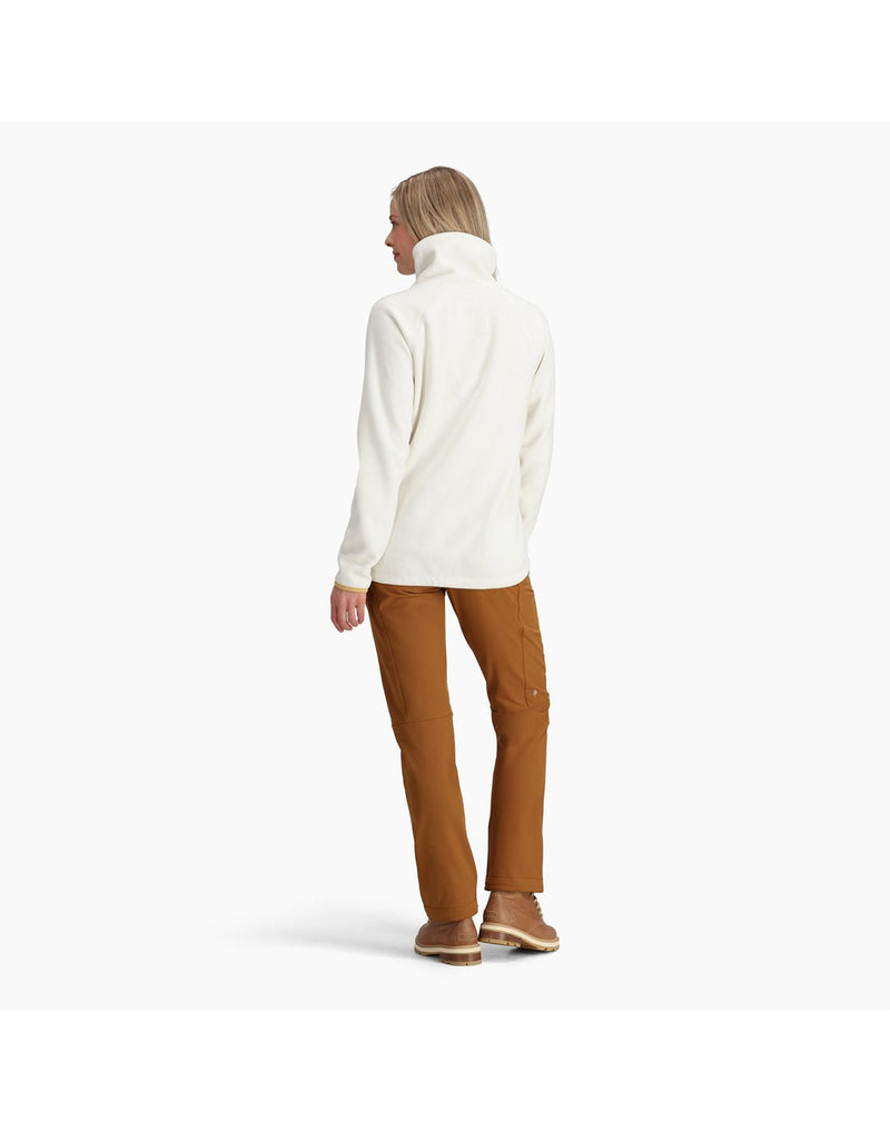 Back view of a woman wearing the Royal Robbins Women's Arete Funnel Neck top in Ivory.