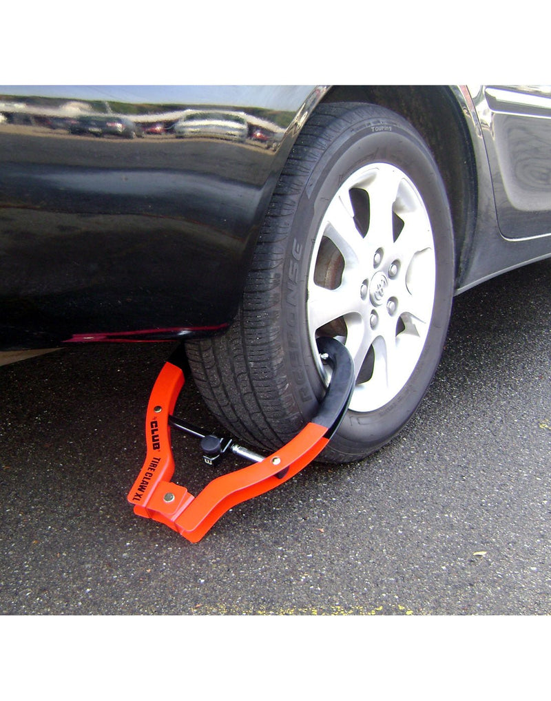 Lifestyle image of The Club® Tire Claw XL affixed to a car tire