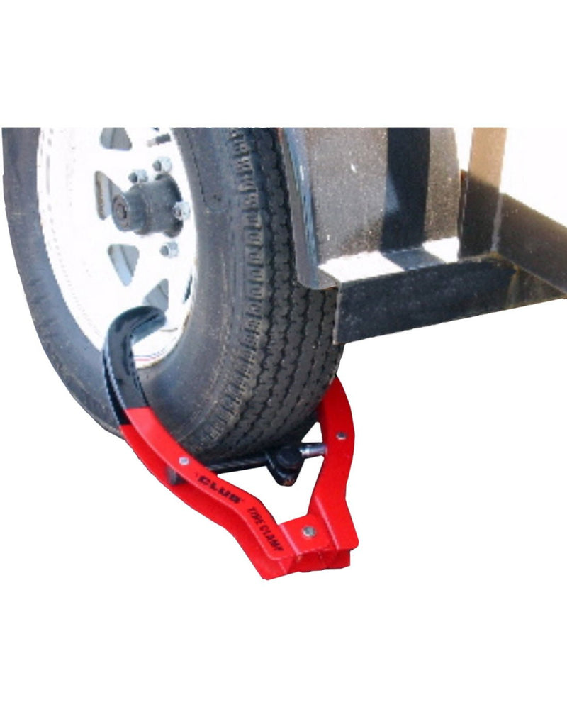 Lifestyle image of The Club® Tire Claw XL affixed to a trailer tire