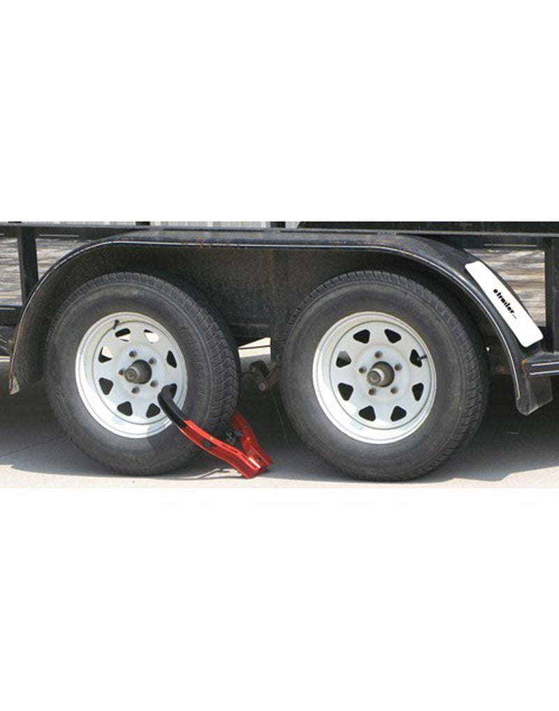 Lifestyle image of The Club® Tire Claw XL affixed to a double wheeled trailer