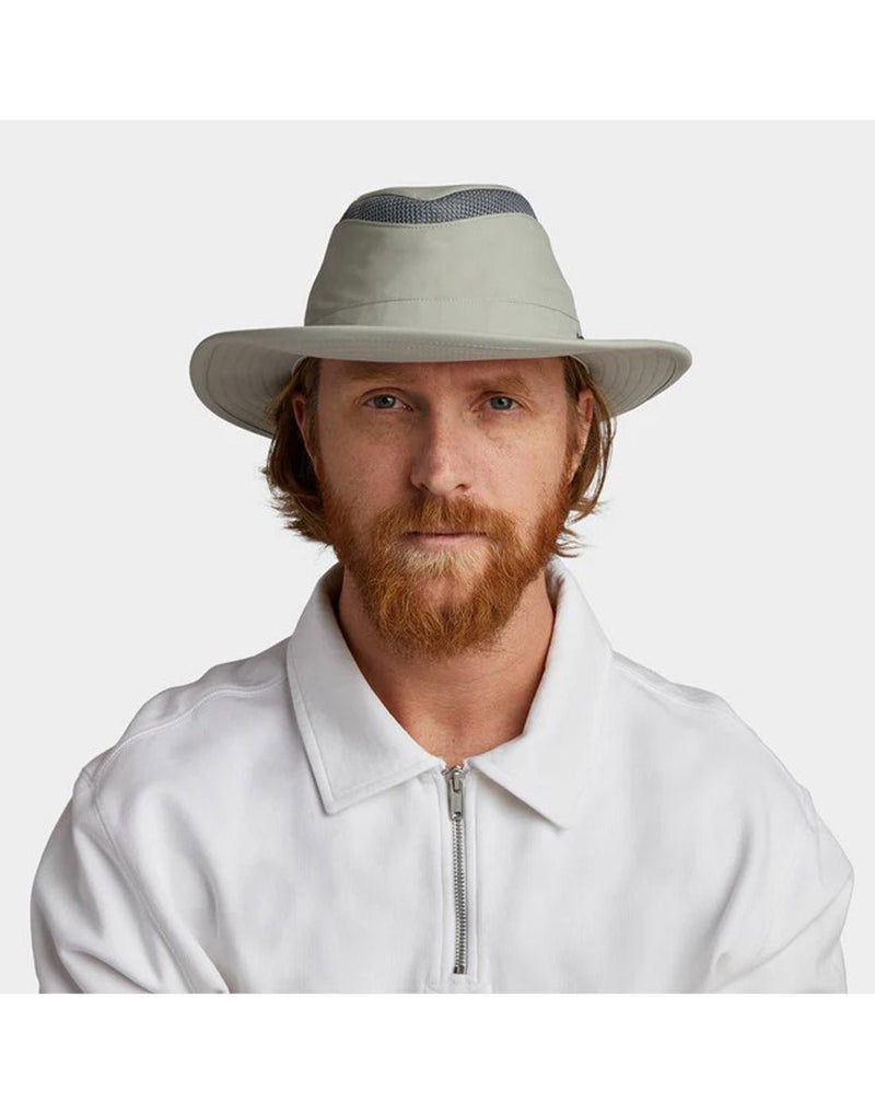 Man wearing white shirt with Tilley LTM6 AIRFLO® Hat in rockface, grey colour, front view