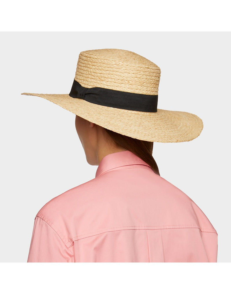 Back of woman wearing pink shirt and the Tilley Raffia Wide Brimmed Hat