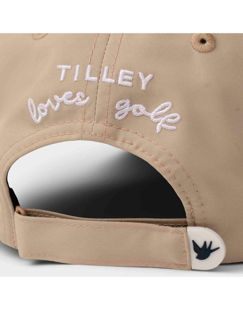 Close up of white stitched words Tilley loves golf on back of light tan Tilley T Golf Cap