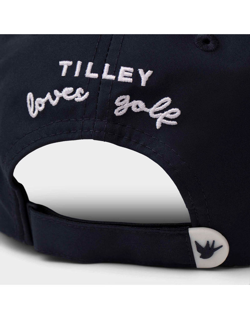 Close up of white stitched words Tilley loves golf on back of dark navy Tilley T Golf Cap
