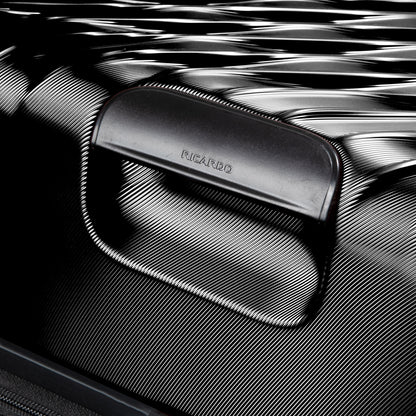 Close-up of Ricardo Beverly Hills Melrose 20" Hardside Spinner Carry-on handle and textured black surface.