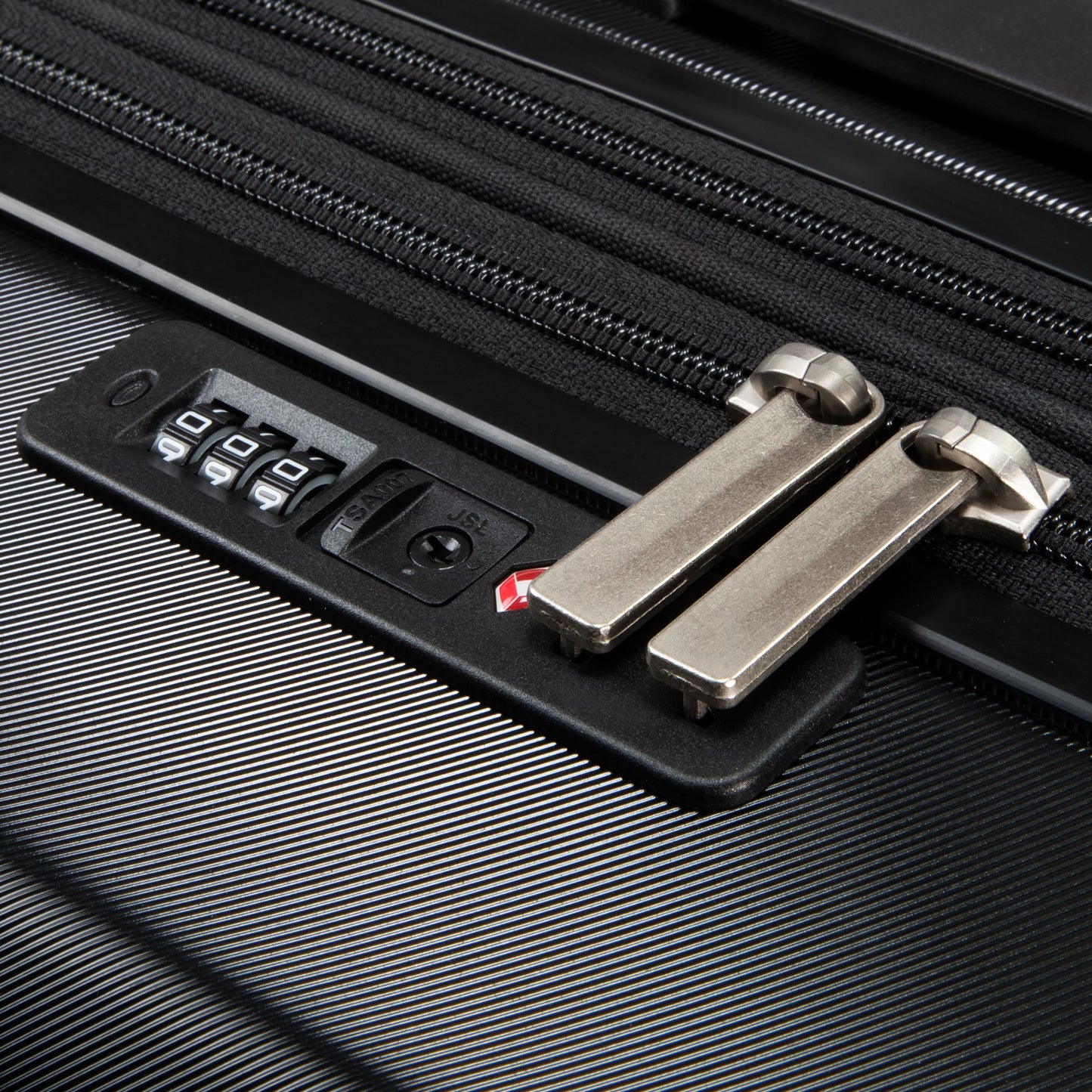 Close-up of Ricardo Beverly Hills Melrose 20" Carry-on zipper with built-in locked combination lock.