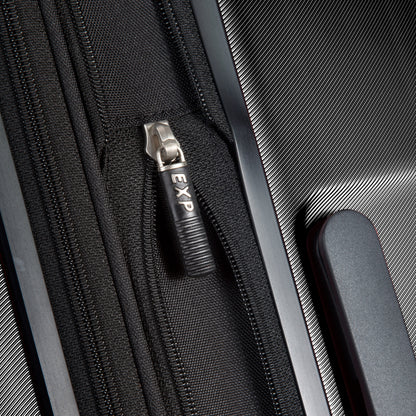 Close-up of the "EXP" zipper on Ricardo Beverly Hills Melrose 25" Hardside Spinner with sturdy handle.
