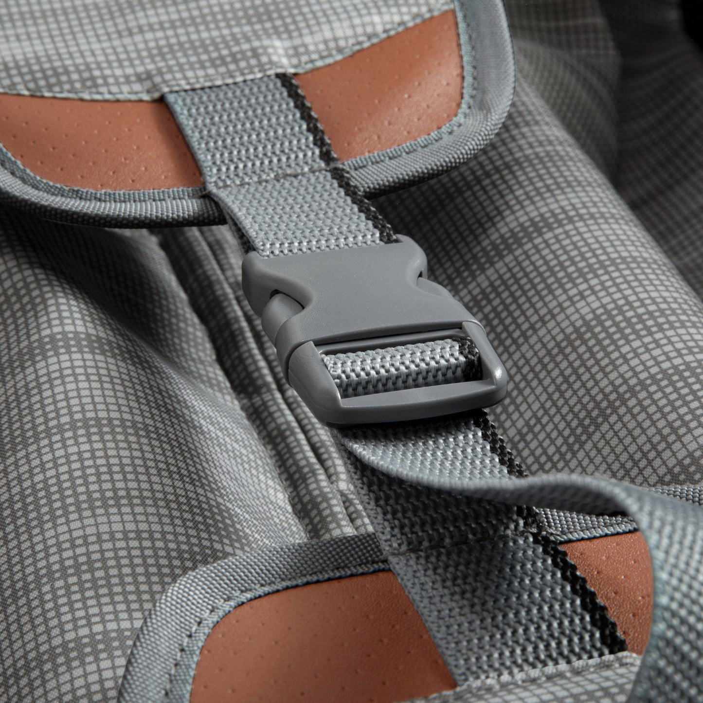 Close-up of a gray buckle and strap with checks and brown accents on the Ricardo Beverly Hills Montecito 2.0 carry-on.