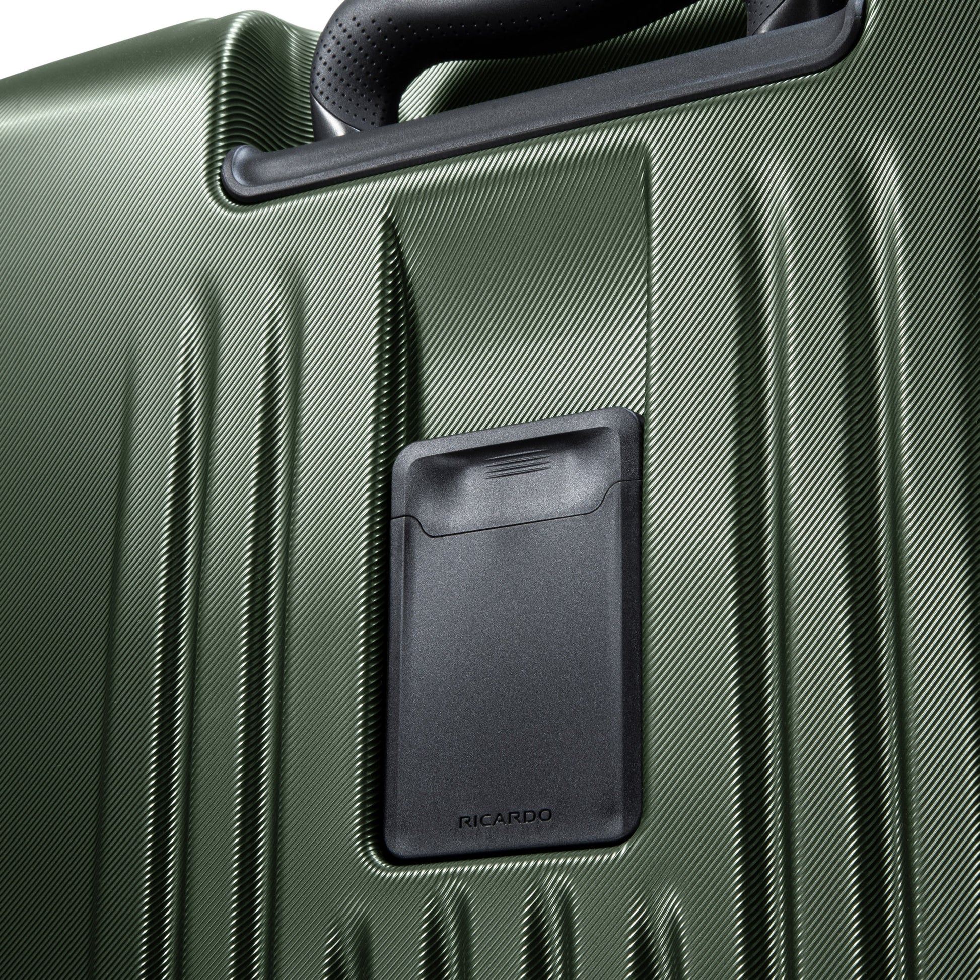 Close-up of the Ricardo Beverly Hills Montecito 2.0 green hardside suitcase with expandable storage and a black handle.