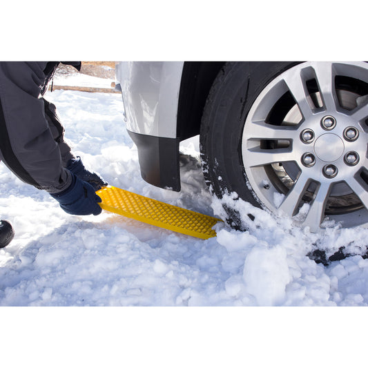 Product Image – A person uses a SubZero® GripTrax™ Traction Tool to help a car tire stuck in snow.