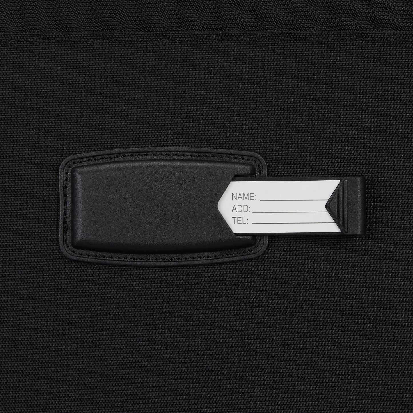 Close-up of a black luggage tag with ID card—ideal for organizing your High Sierra Pendall Carry-on Wheeled Duffle.