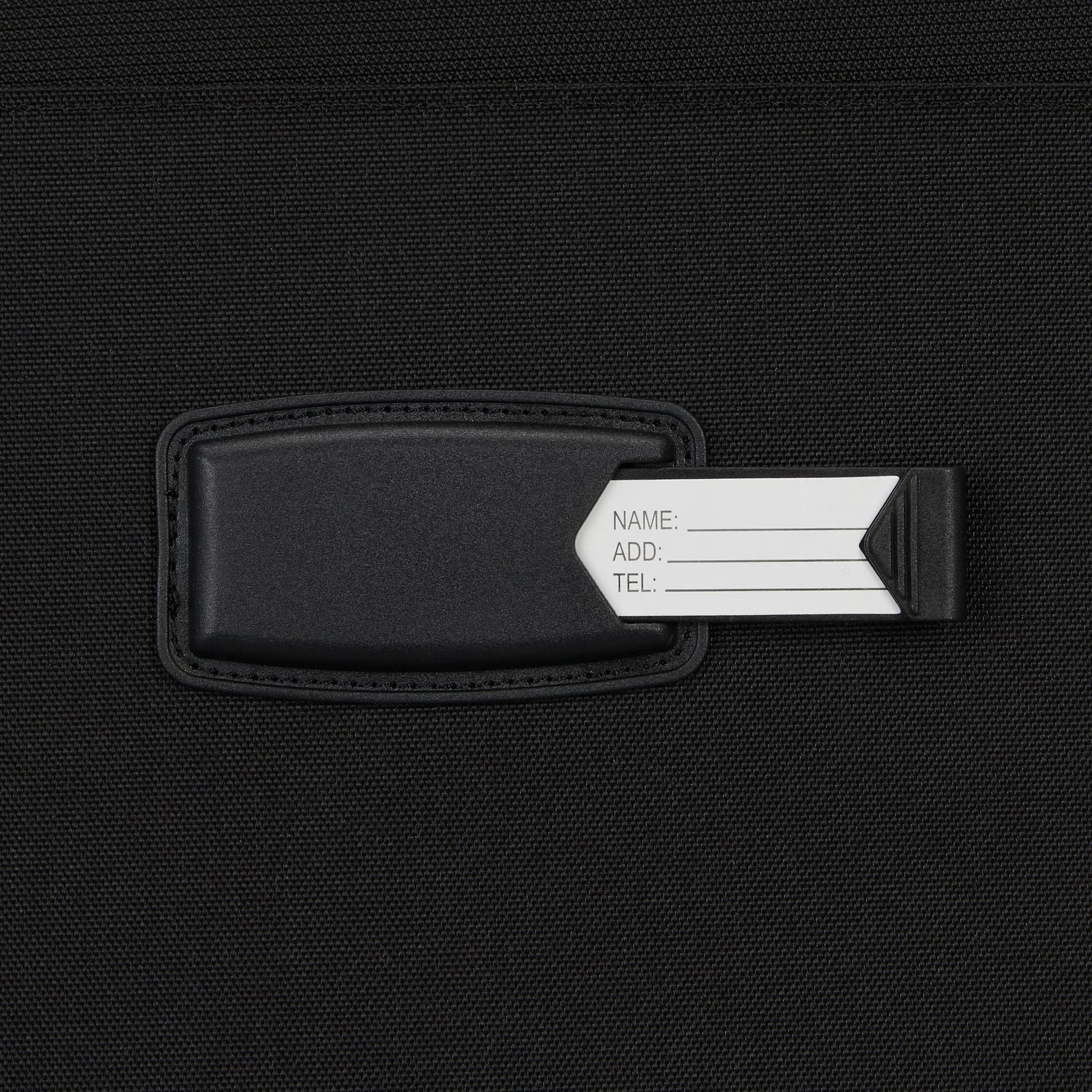 Close-up of a black luggage tag with ID card—ideal for organizing your High Sierra Pendall Carry-on Wheeled Duffle.