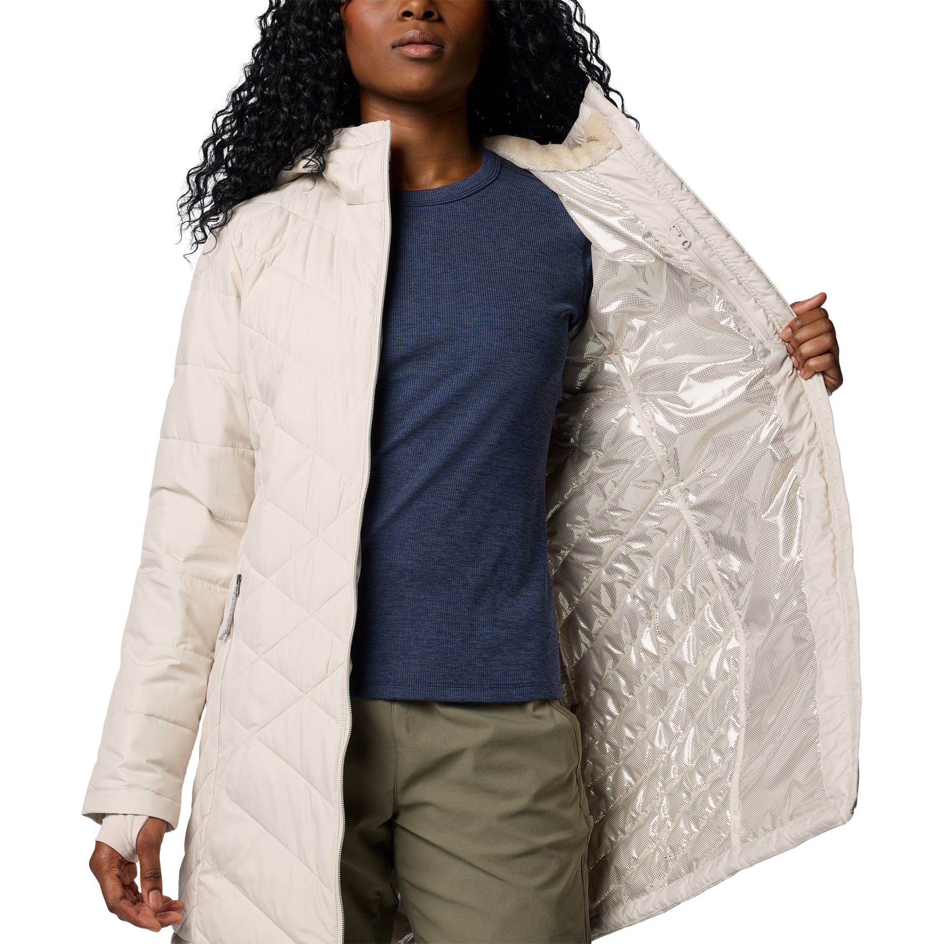 Woman wearing Columbia Women's Heavenly™ Long Hooded Jacket in dark stone, white colour, unzipped, holding one side open to show silver lining