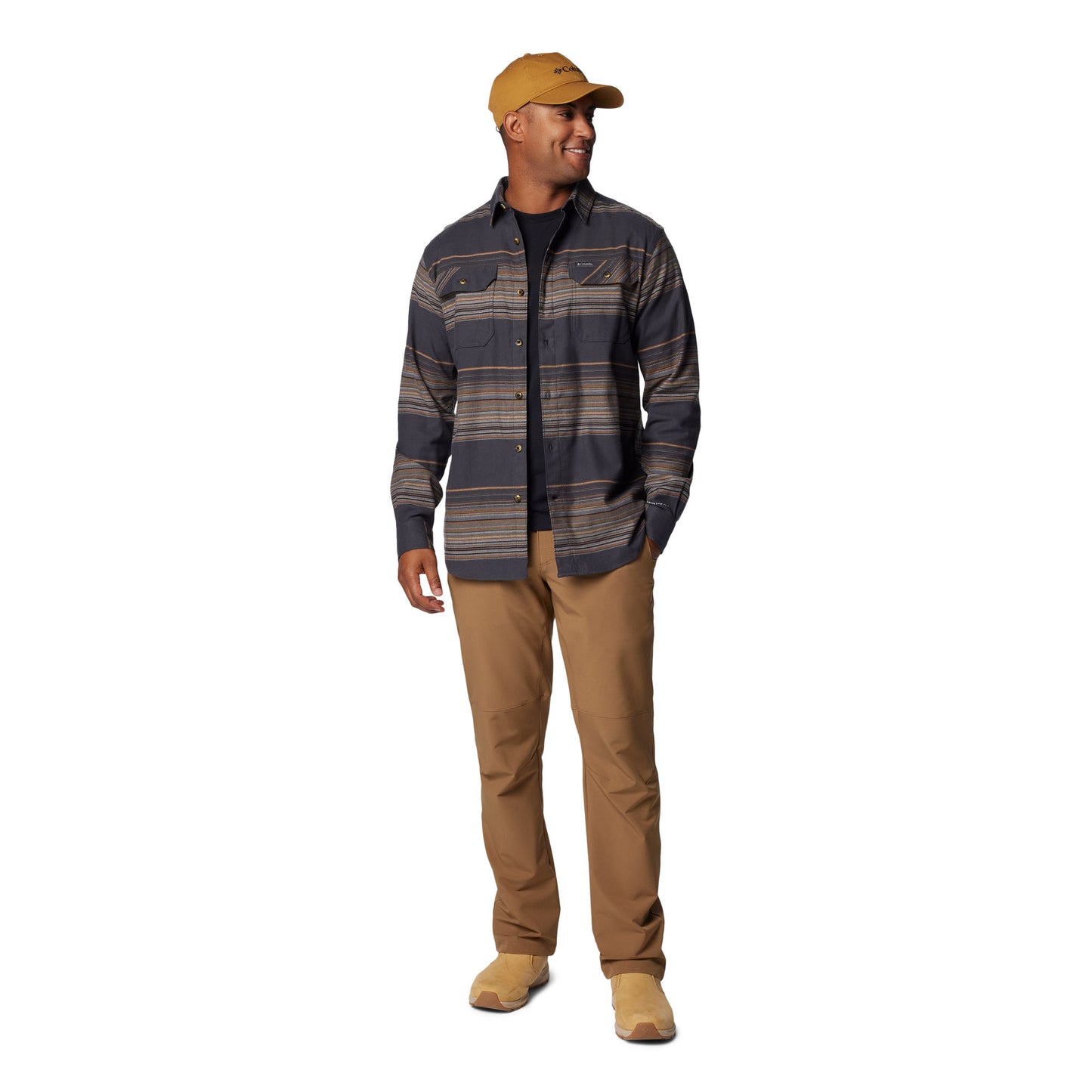 Man wearing Columbia Men's Flare Gun™ Stretch Flannel Shirt, shark lunar stripe, unbuttoned on top of black shirt with tan pants, shoes and hat