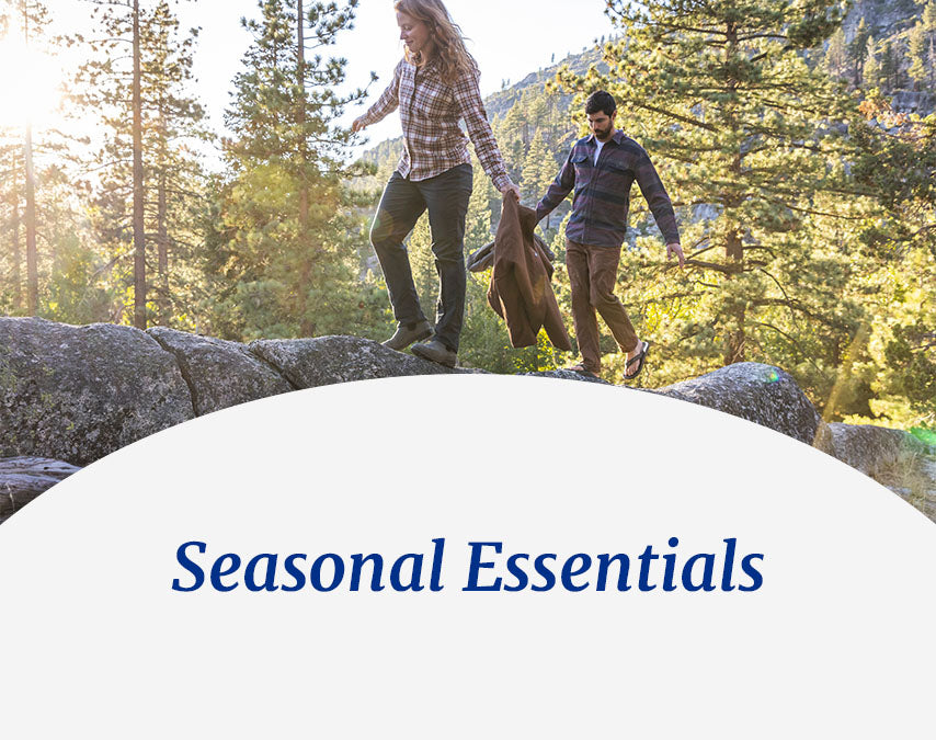 Seasonal Essentials - couple hiking on a mountain hill forest side.