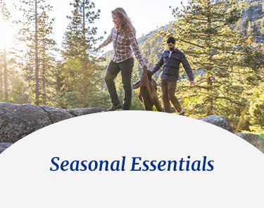 Seasonal Essentials - couple hiking on a mountain hill forest side.