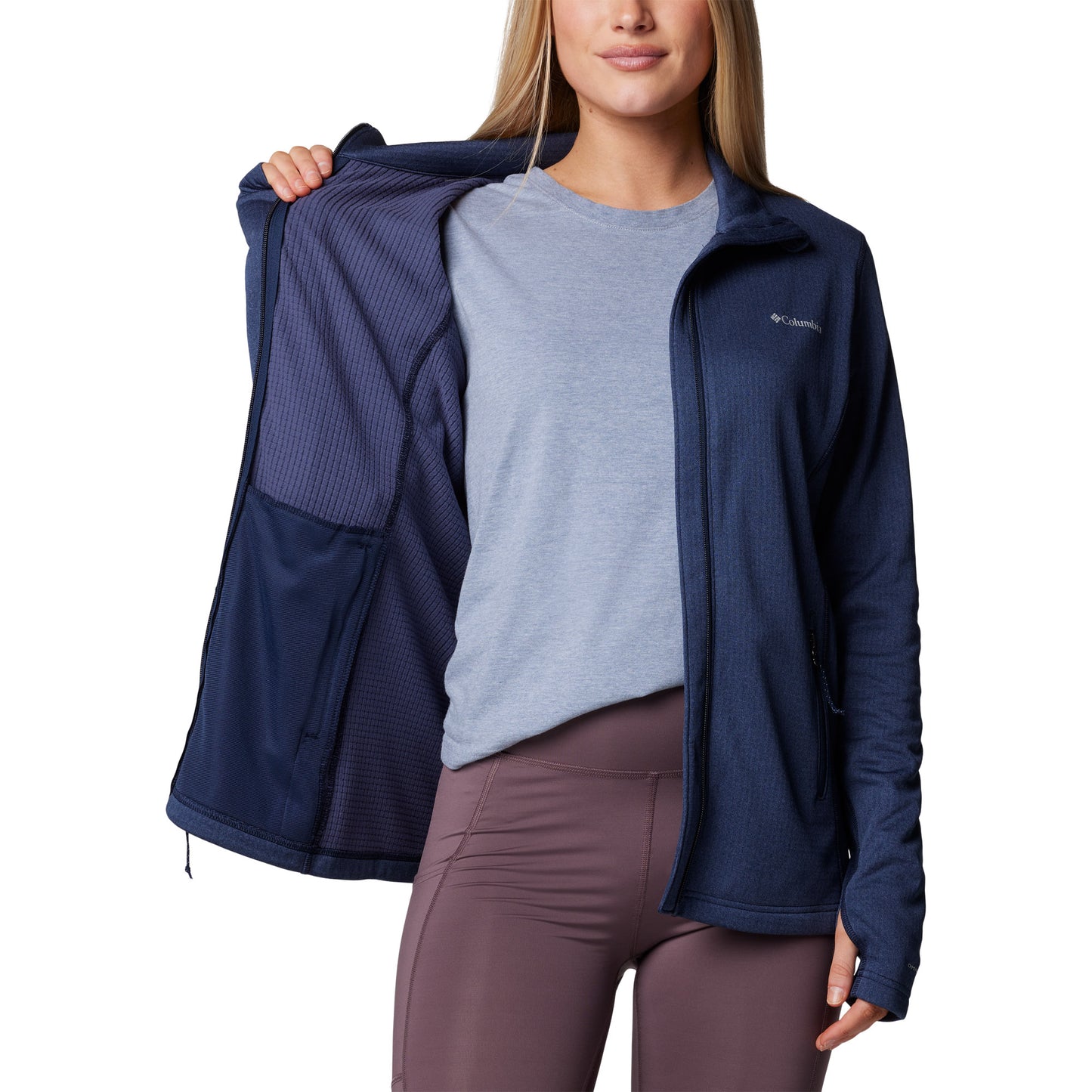 Woman wearing Columbia Women's Park View™ Grid Full Zip Fleece Jacket in collegiate navy blue, front view, unzipped, holding one side open to show interior