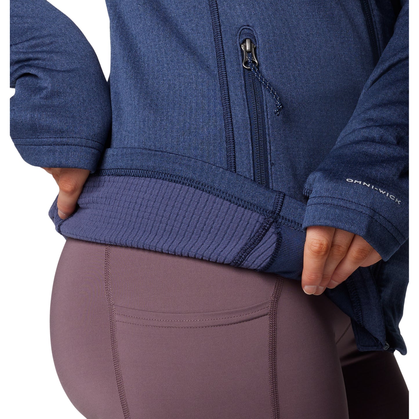 Close up of woman wearing Columbia Women's Park View™ Grid Full Zip Fleece Jacket in collegiate navy blue, holding bottom hem up to show fuzzy interior lining