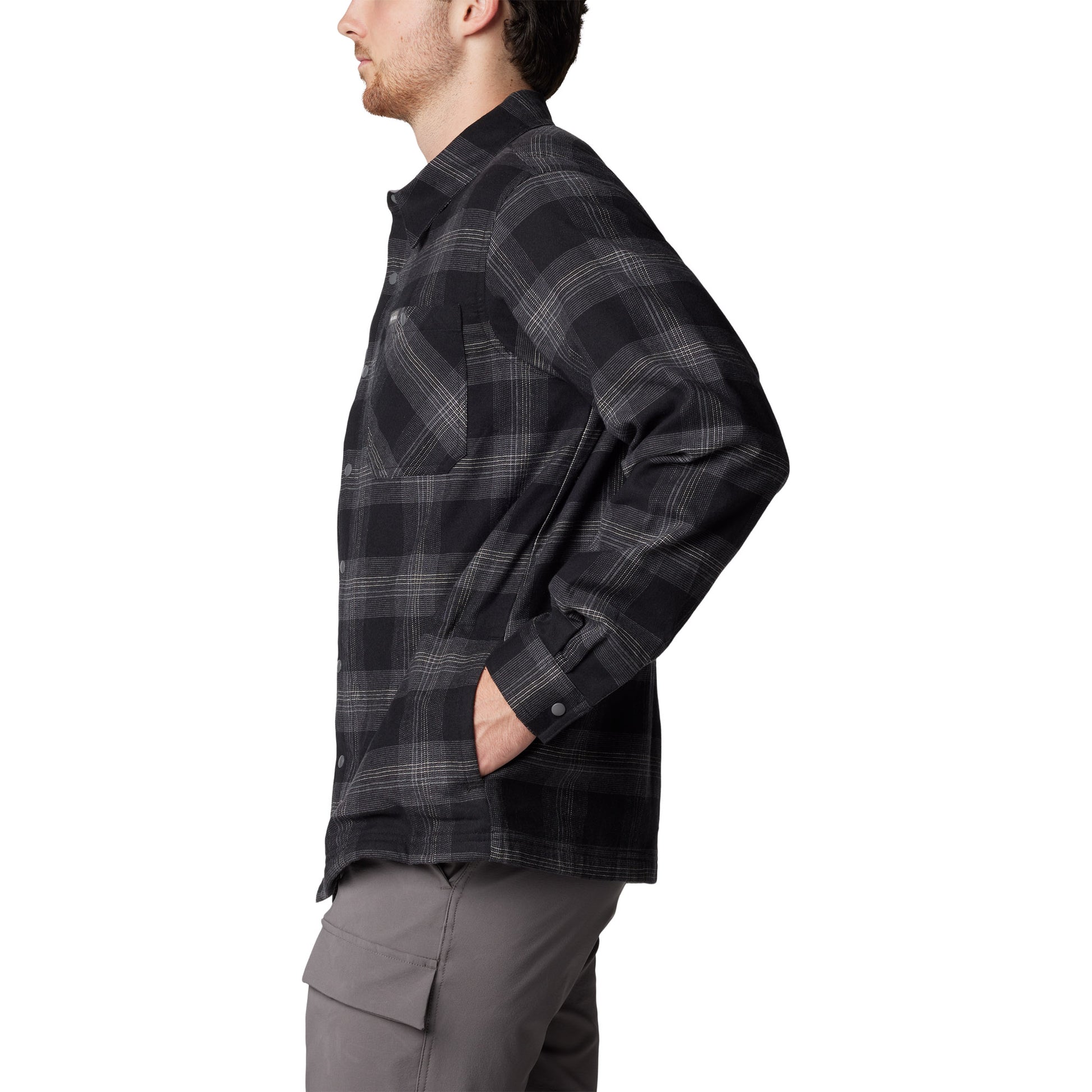 Man wearing Columbia Men's Cornell Woods™ Fleece Lined Shirt Jacket in black buffalo tartan, side view with hands in pockets