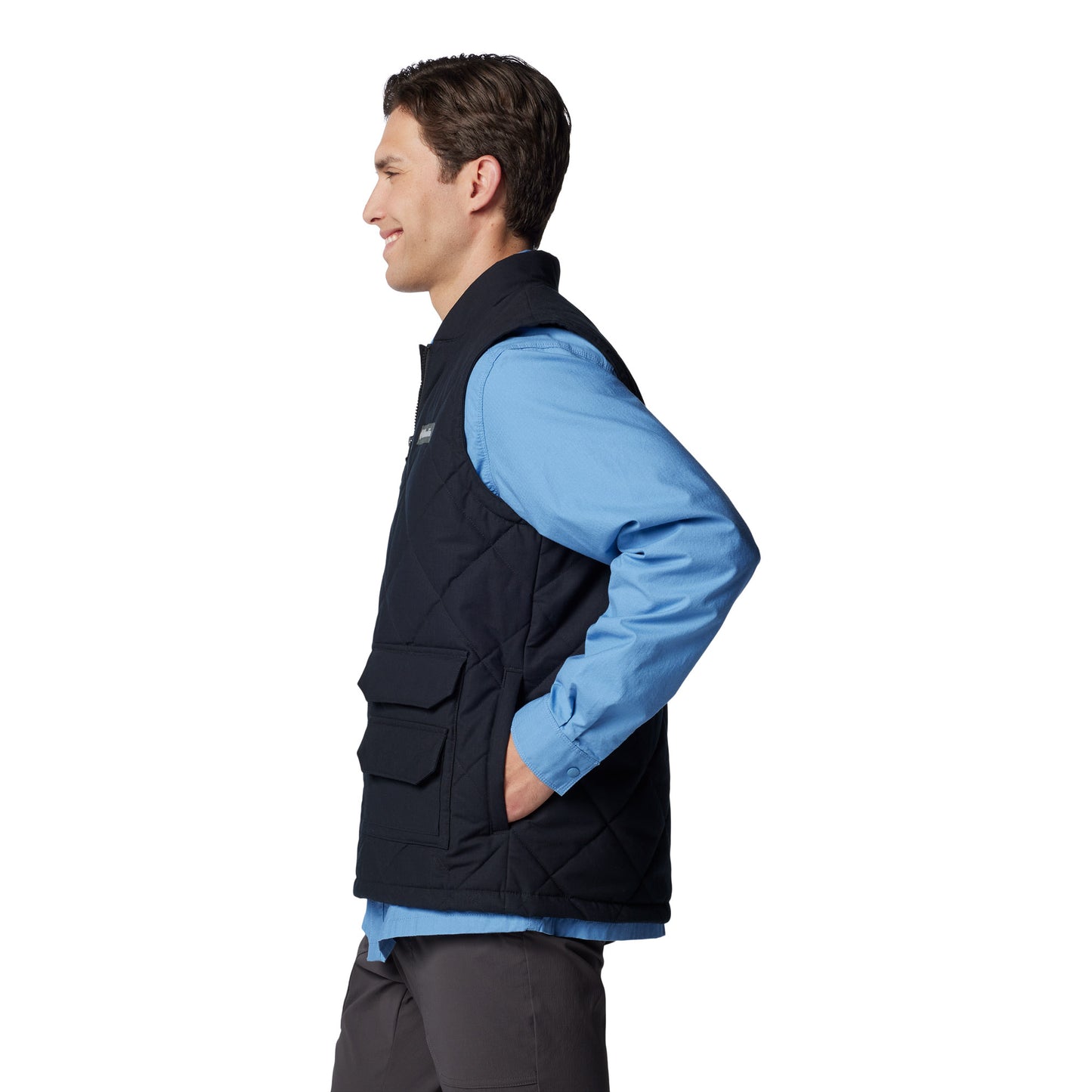 Man wearing Columbia Men's Rad Padded™ Vest in black, side view with hands in pockets