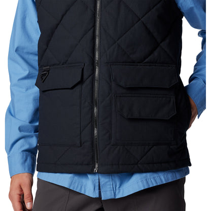 bottom half of man wearing Columbia Men's Rad Padded™ Vest in black, front view, zipped up with one hand in pocket