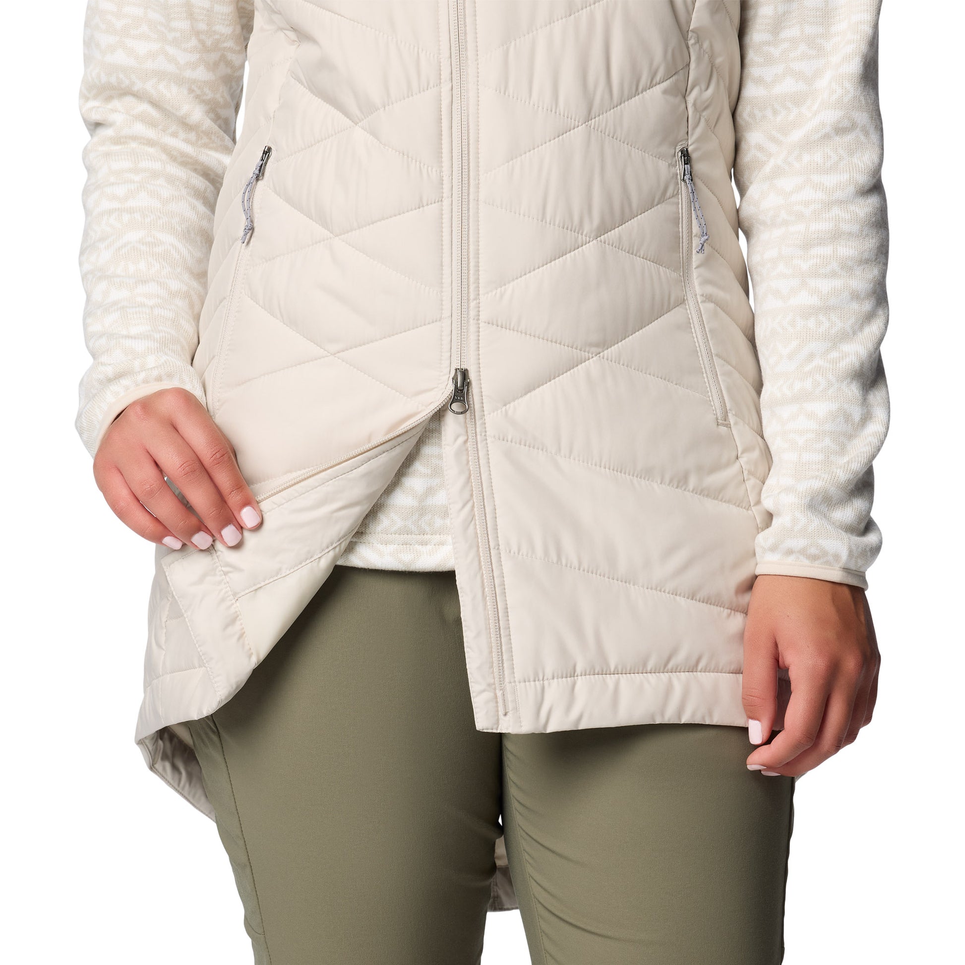 Bottom half of woman wearing Columbia Women's Heavenly™ II Long Vest in dark stone, with two-way zipper unzipped partially from bottom up