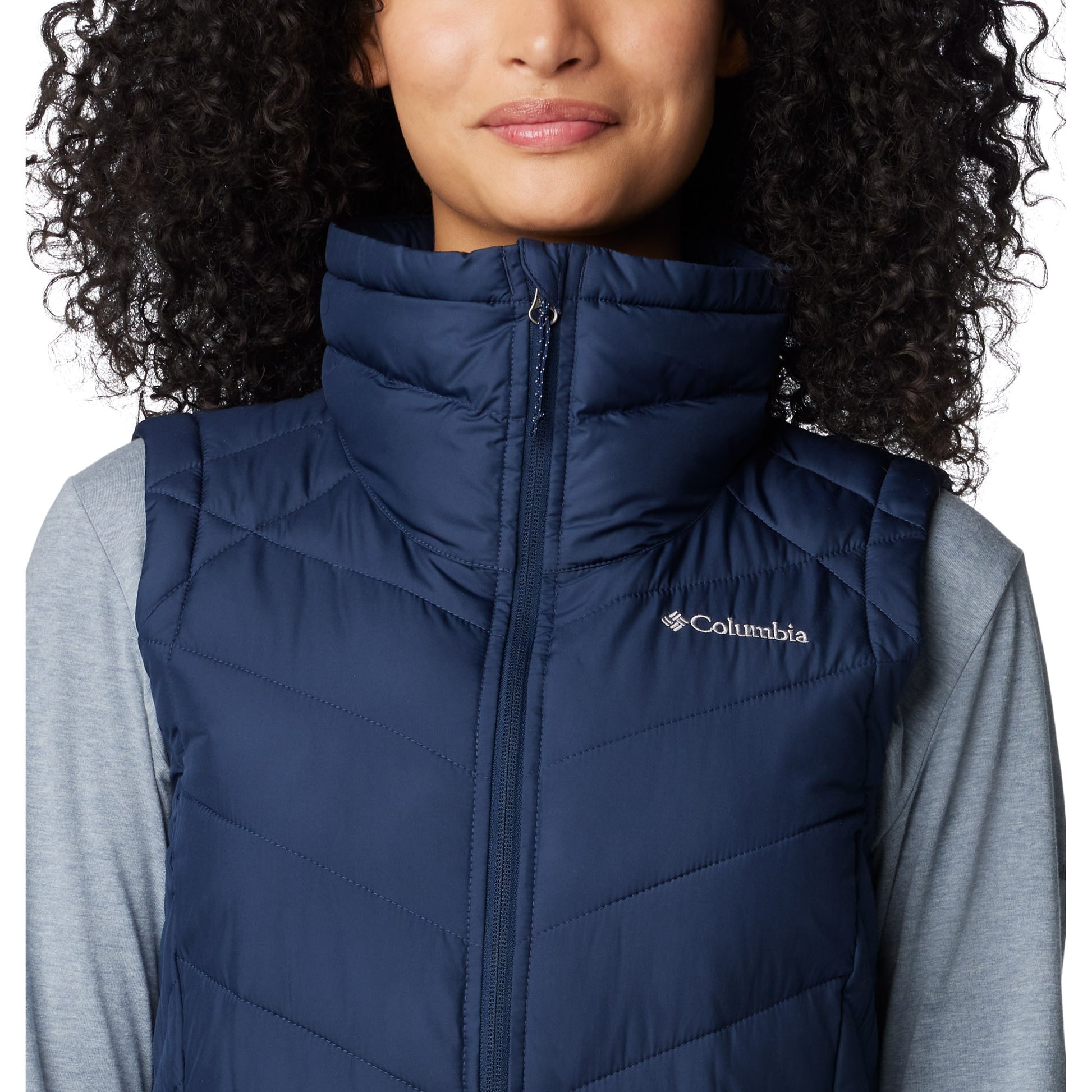 Top half of woman wearing Columbia Women's Heavenly™ II Long Vest in collegiate navy, zipped up