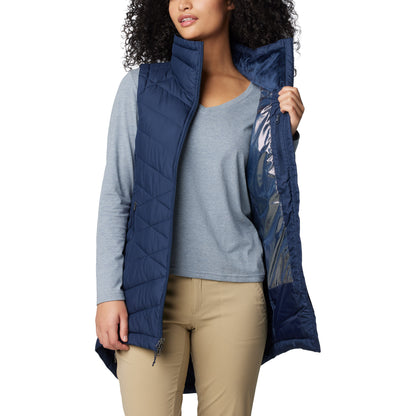 Woman wearing Columbia Women's Heavenly™ II Long Vest in collegiate navy, unzipped, holding one side open to show omni-heat silver lining