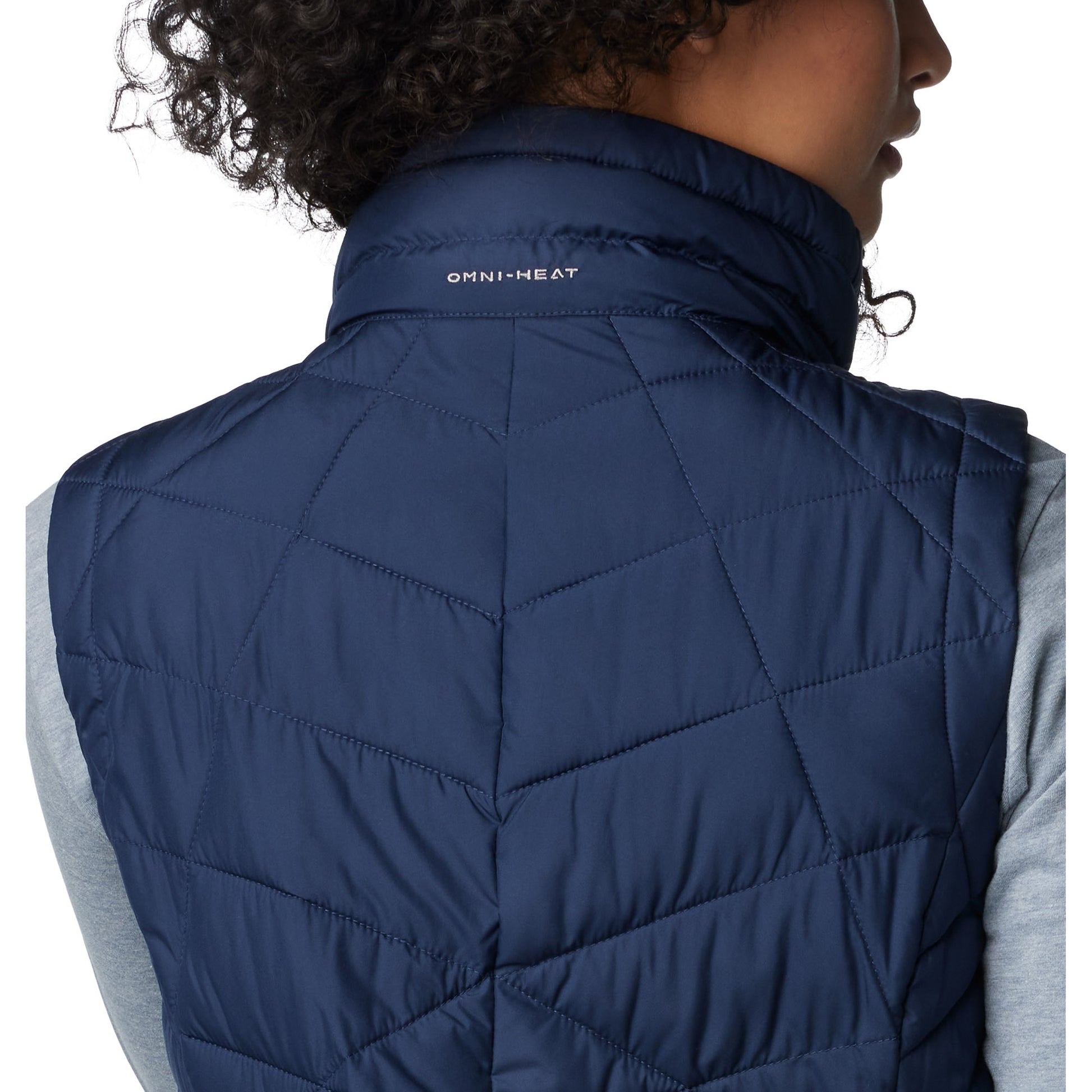 Top back half of woman wearing Columbia Women's Heavenly™ II Long Vest in collegiate navy