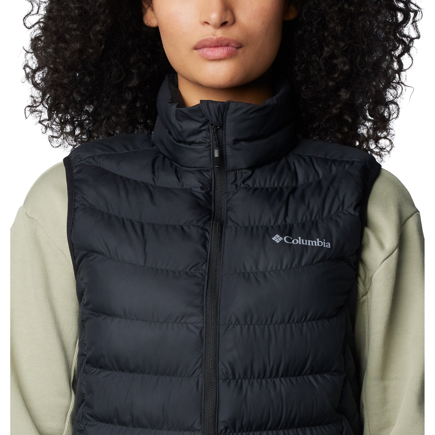 Top half of woman wearing Columbia Women's Powder Lite™ II Vest in black, zipped up