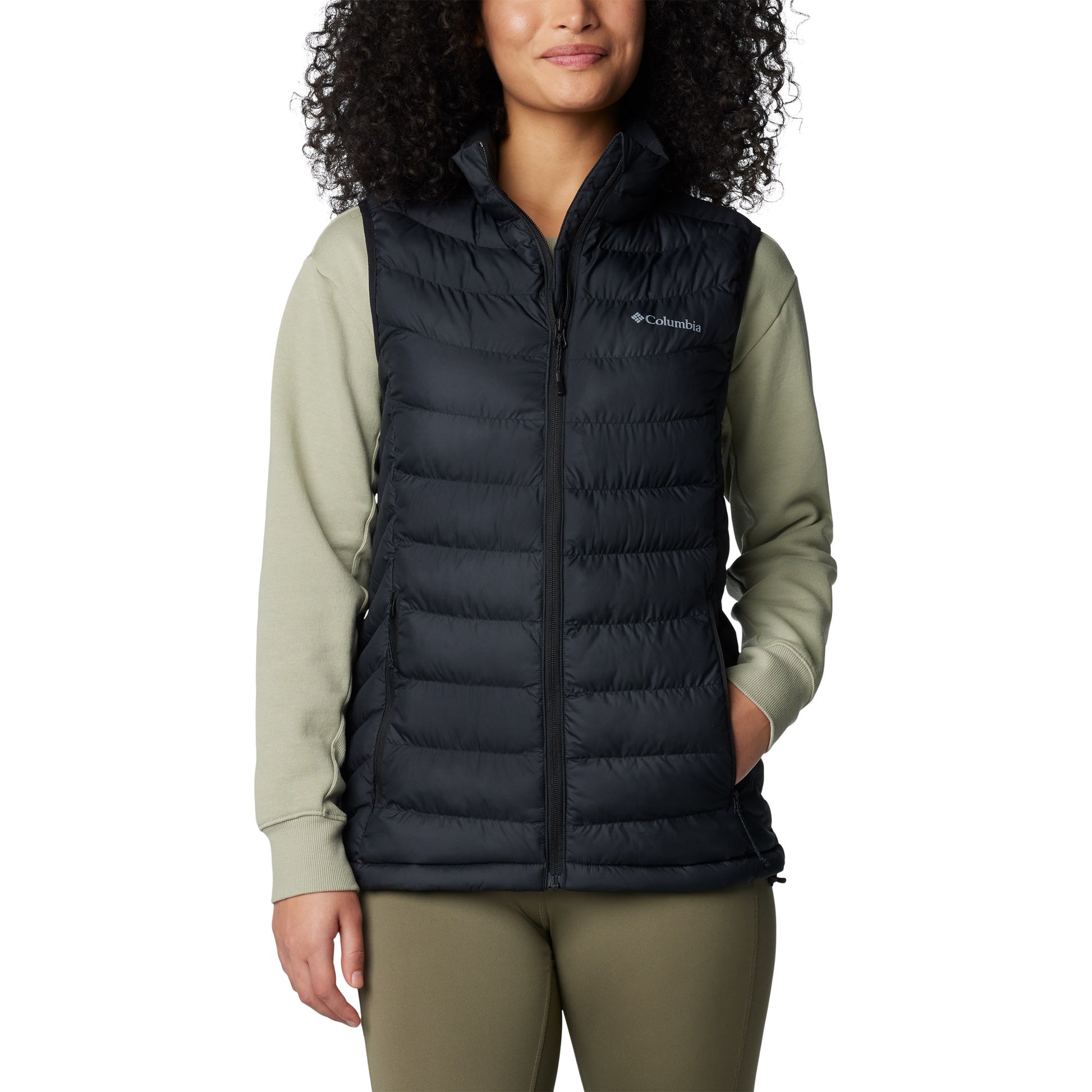 Woman wearing Columbia Women's Powder Lite™ II Vest in black, front view, zipped up with one hand in pocket