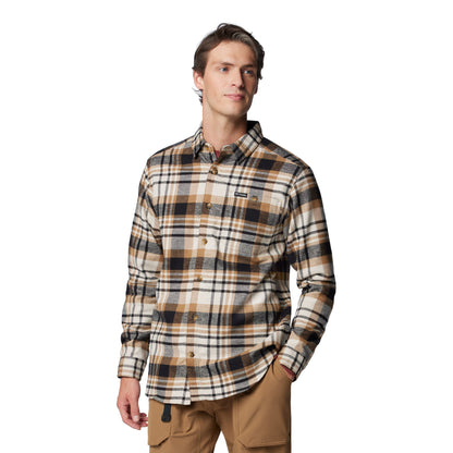 Man wearing Columbia Men's Pitchstone™ Heavyweight Flannel II in delta multi plaid, black, tan, and beige colour, front view, buttoned up, with one hand in pocket