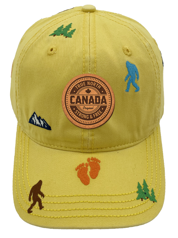 Northern Icons Canada Mountain Yeti Embroidered Cap in golden yellow with Canada patch on front and embroidered yetis, footprints, trees and mountains all over.