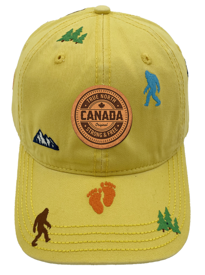 Northern Icons Canada Mountain Yeti Embroidered Cap in golden yellow with Canada patch on front and embroidered yetis, footprints, trees and mountains all over.