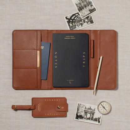 Fringe Jet Setter Travel Folio Set in brown faux leather with a notebook, pen, luggage tag, and vintage photos.