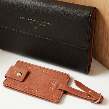 Fringe Jet Setter Travel Folio Set in black faux leather with gold text and a tan “Explore” and “Journey” luggage tag.