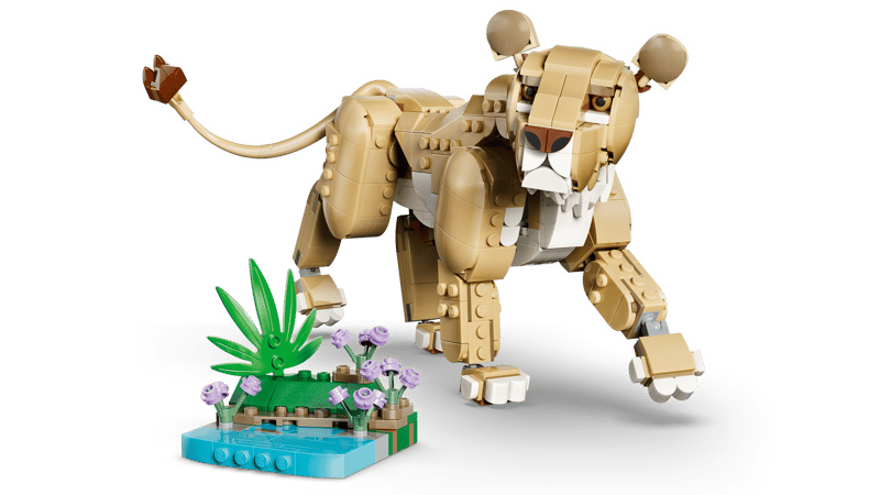 LEGO® Wild Animals: Majestic Lion stands on all fours by a LEGO plant and water scene. Online only.