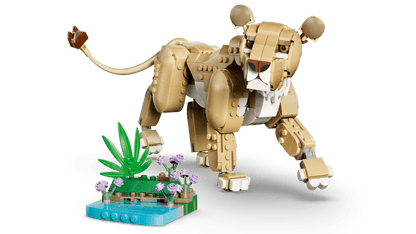LEGO® Wild Animals: Majestic Lion stands on all fours by a LEGO plant and water scene. Online only.