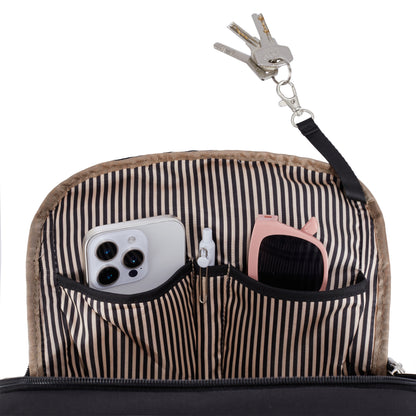 Unzip Travelon Anti-theft Heritage Backpack to reveal RFID pockets with keys, iPhone, and pink case inside.