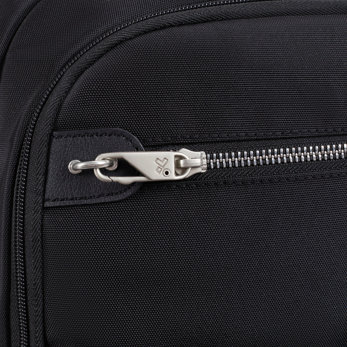 Close-up of a silver zipper on the Travelon Anti-theft Heritage Backpack, highlighting anti-theft details and logo.