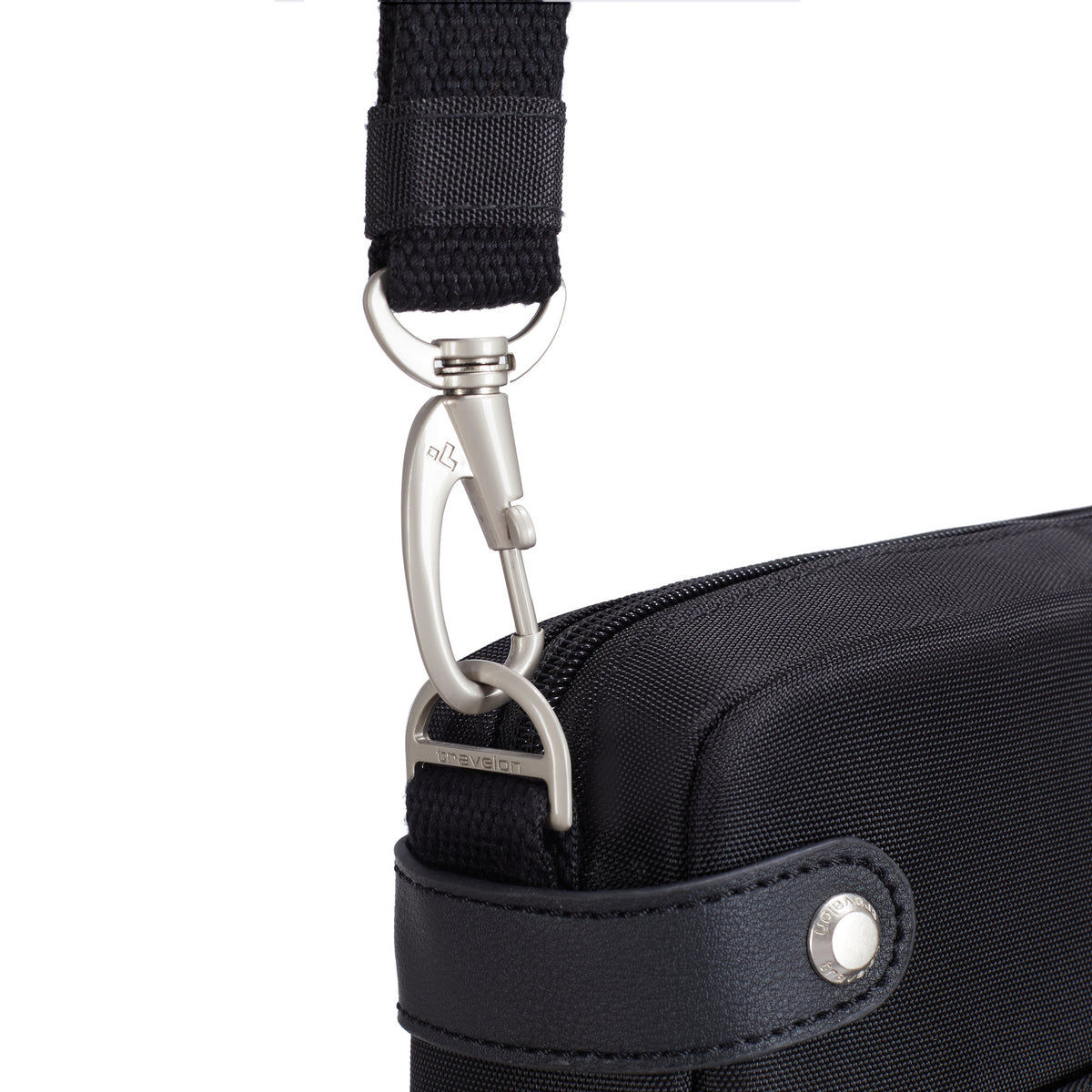 Close-up of a metal clasp connecting a black strap to the Travelon Anti-theft Heritage Crossbody bag.
