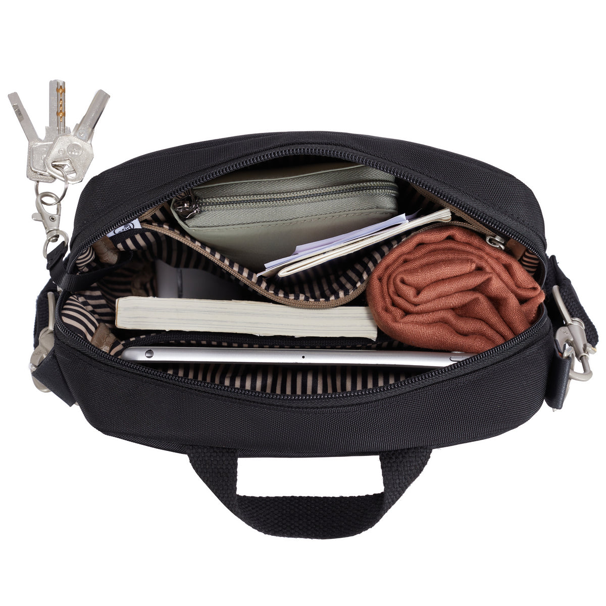 Open Travelon Anti-theft Heritage Tour Bag with keys, wallet, notebook, shirt, and papers visible inside.