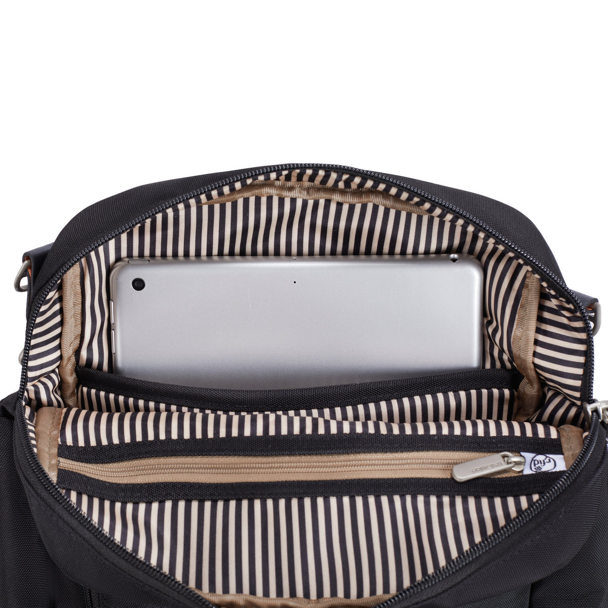 Open Travelon Anti-theft Heritage Tour Bag with striped lining, tablet, and zippered pouch inside.
