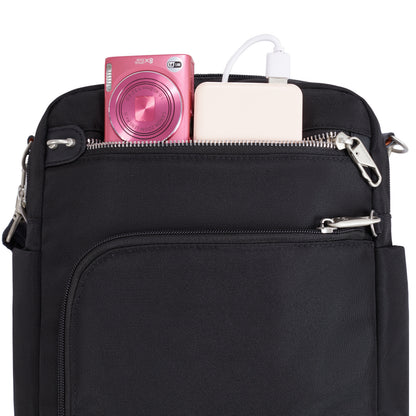 Travelon Anti-theft Heritage Tour Bag in black with a pink camera and white power bank in the top pocket.